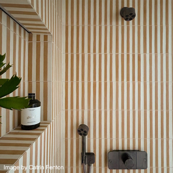 encaustic cement mustard stripe tiles in bathroom shower cubicle