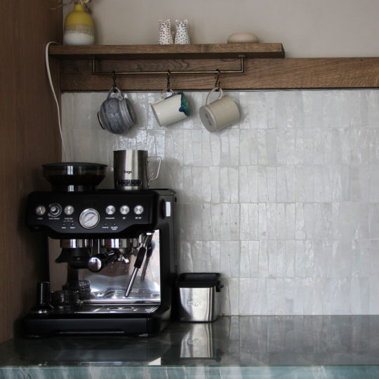 White trapezoid zellige tiles kitchen splashback